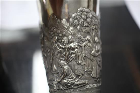 Two Indian white metal beakers, each embossed with scenes of women making offerings to Lord Shiva